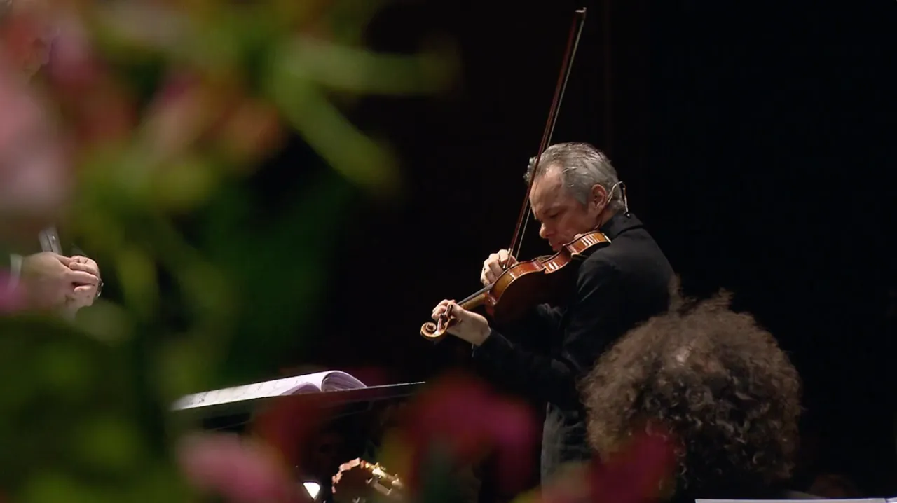 Benjamin Schmid playing the violin, with flowers in the foreground
