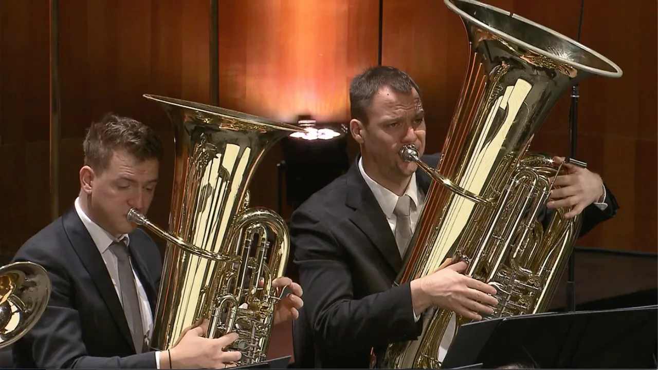 Two musicians of the Bläserphilharmonie Mozarteum Salzburg playing low brass instruments