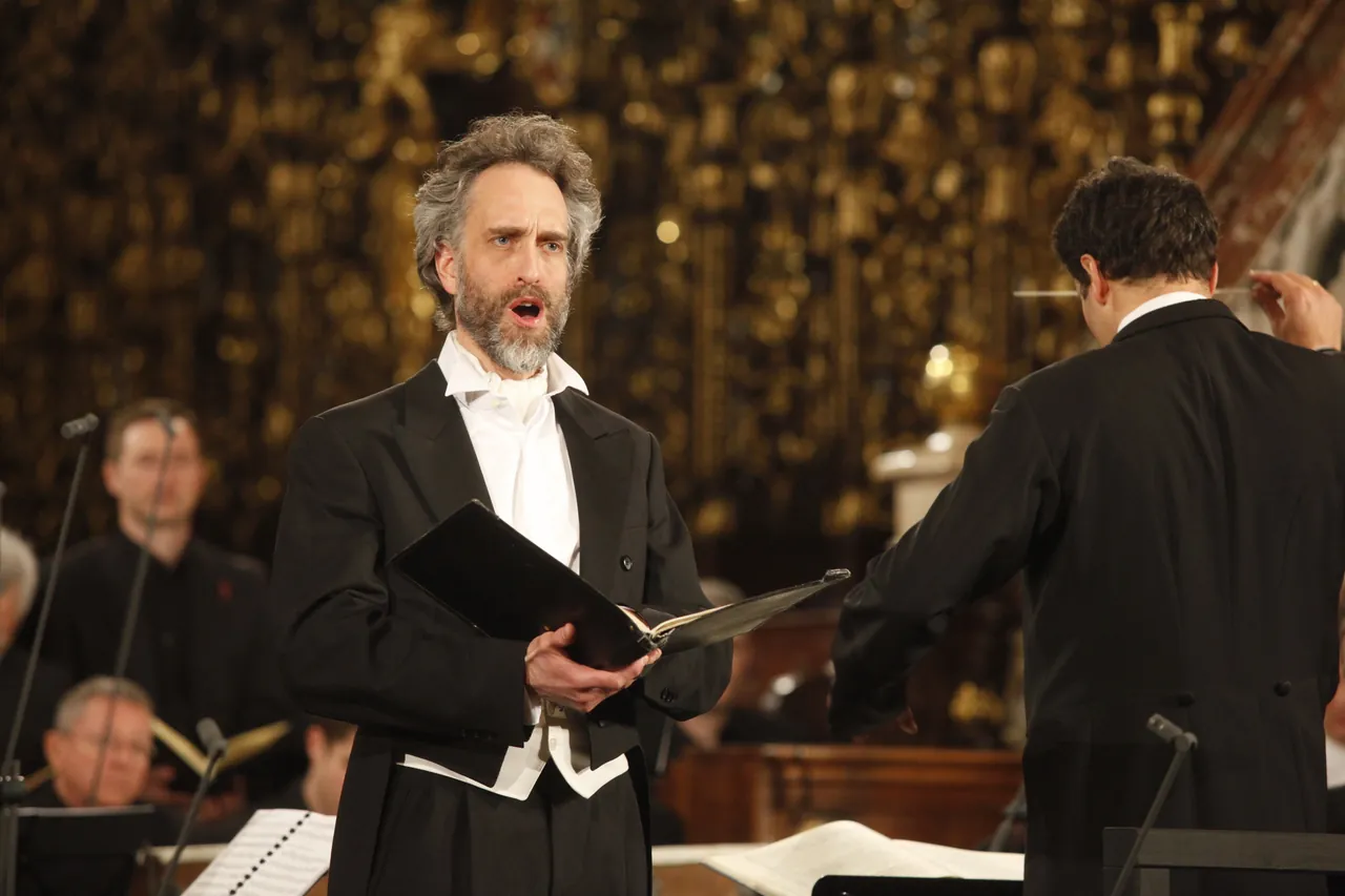 Christian Immler canta; en primer plano, Rubén Dubrovsky dirige