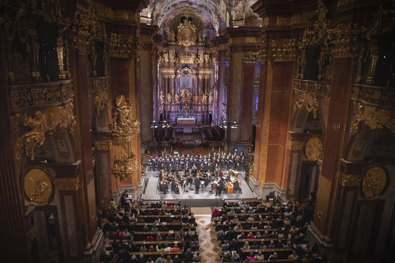 View across the audience to the stage and high altar of the abbey church of Melk at the 2023 opening concert