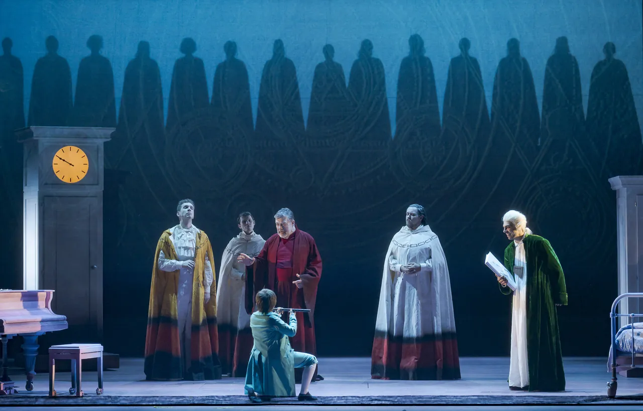Priests, Carl Thomas, Sarastro and Mozart before a row of shadow figures